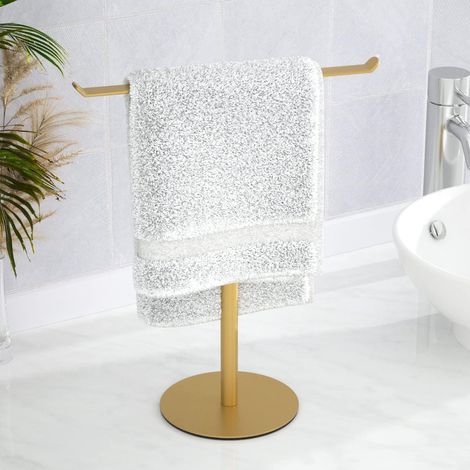 Portasciugamani con base rotonda dorata, largo 27 cm e alto 30 cm, progettato per essere posizionato sul piano del bagno. (1/5)