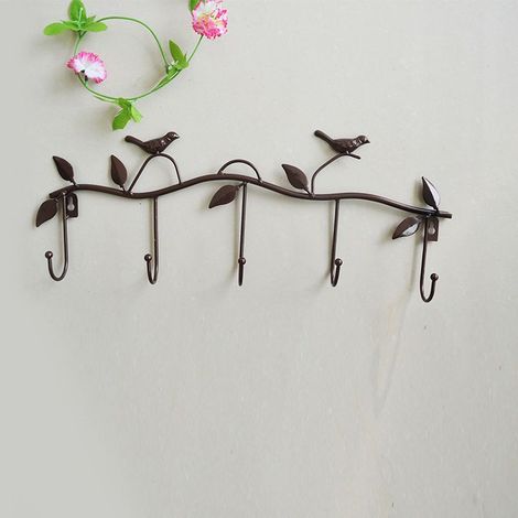 Robuste Wandhaken aus Eisen, verziert mit Blättern und Vögeln – Bronze. (1/5)