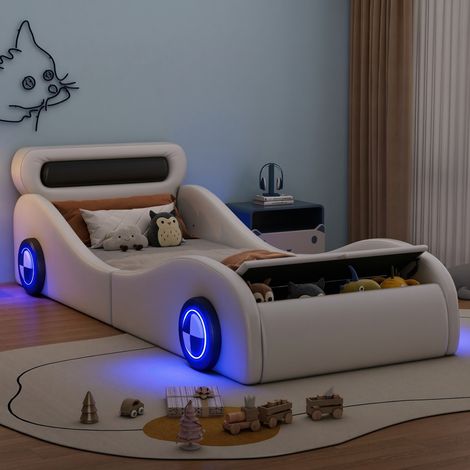 MODFU – Letto per bambini a forma di auto 90x200 cm in PU/MDF con ruote luminose regolabili da app, vano contenitore e bordi imbottiti – Bianco (1/5)