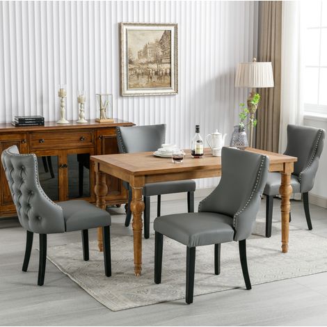 Esszimmerstuhl 4er-Set grau, gepolstert aus PU mit Knopfrücken und schwarzen Holzbeinen (1/2)