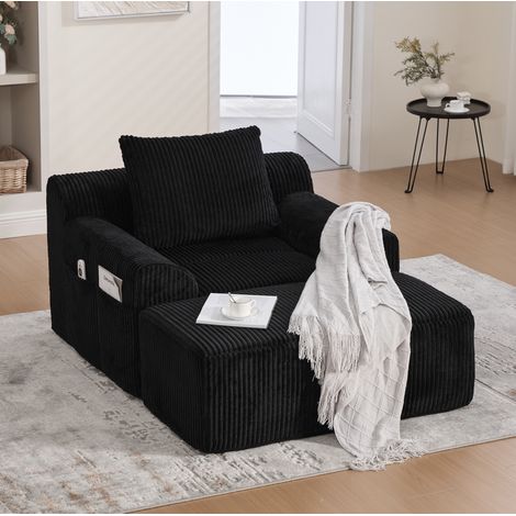 Poltrona oversize 147x110x67 cm nera in velluto a coste con poggiapiedi e tasche laterali (1/5)