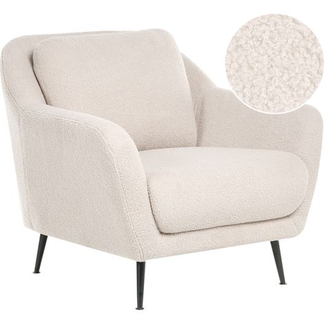Sillón tapizado de bouclé patas de hierro negras con reposabrazos asiento grueso estilo moderno salón beige Eiby