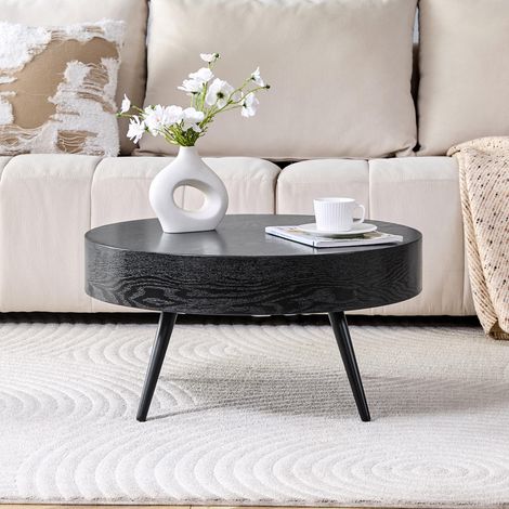Table basse ronde de 70 cm de diamètre, en MDF aspect bois noir et pieds en métal noir. Design minimaliste, idéal pour les salons et les petits espaces.