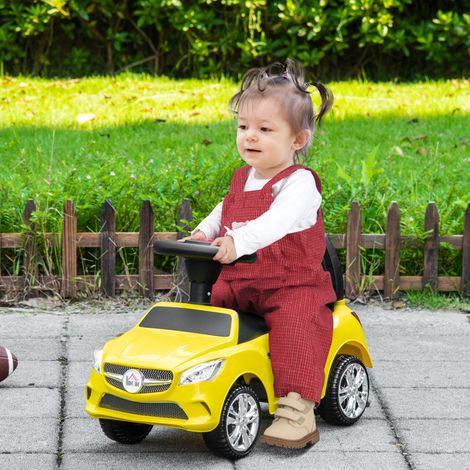 Elektrisches Kinderauto mit Lenkrad, Scheinwerfern und integrierter Musik, aus Polypropylen und Metall, 63,5 x 28 x 36 cm, gelb (1/5)