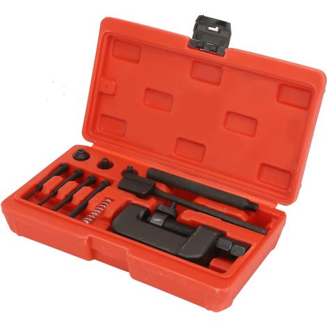 Kit d'outils de réparation pour moto : dérive-chaîne, séparateur de maillons et riveteuse.