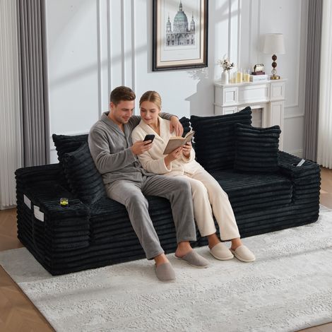 Canapé-lit noir en velours côtelé avec assise compressible, dossier surélevé, coussins additionnels, rangements latéraux et support boissons, rembourrage moelleux pour confort optimal (1/4)
