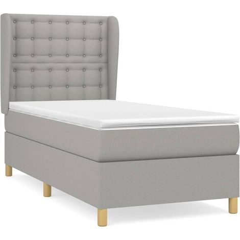Cadre de lit à lattes avec un matelas gris clair (80x200 cm), recouvert de tissu.