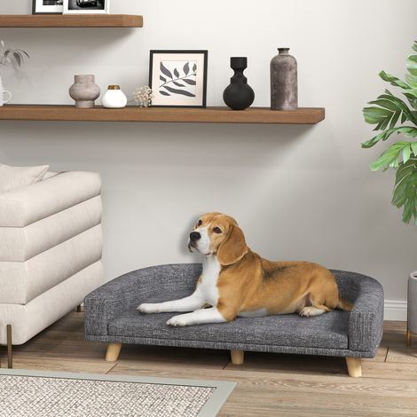 Divano per cani di grandi dimensioni, cuccia rialzata con cuscino lavabile e gambe in legno, portata massima 40 kg, dimensioni 98x67x25 cm, colore grigio scuro.
