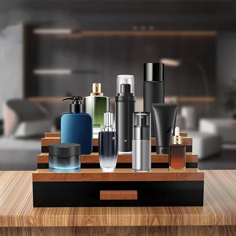 Un présentoir à parfums noir à plusieurs niveaux avec tiroirs, une boîte à bijoux et des rangements à plusieurs niveaux. (1/5)