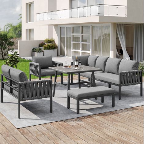 Conjunto de muebles de jardín de metal gris con sofá esquinero, sillón, banco, mesa de vidrio templado y cojines (1/5)