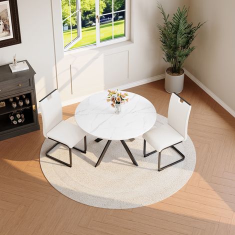 Ensemble salle à manger table ronde marbre 2 chaises blanches similicuir structure métallique porte-à-faux moderne