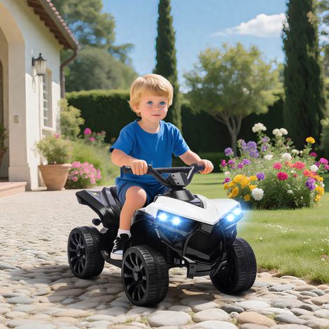 Quad eléctrico infantil con batería recargable de 6 V, faros LED y música, para niños de 3 a 6 años, color blanco.