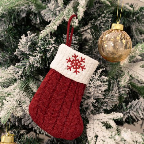 Des mini chaussettes de Noël rouges tricotées, de 18 cm de long, brodées de flocons de neige, peuvent être suspendues au-dessus de la cheminée comme décorations de Noël.