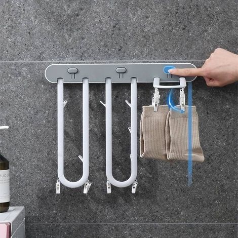 Étendoir à linge mural pliable avec crochets, facile à installer et stable.