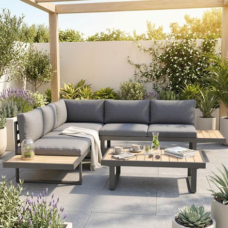 Ensemble de salon de jardin d'angle design. Comprend 5 places assises, des coussins et une table basse en aluminium. Disponible en gris anthracite et en finition imitation bois.