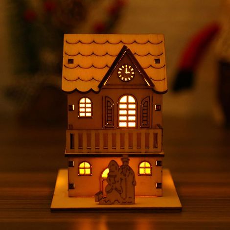 dirigéUne cabane en bois lumineuse, fabriquée en bois naturel, à utiliser comme décoration de table festive. (1/5)