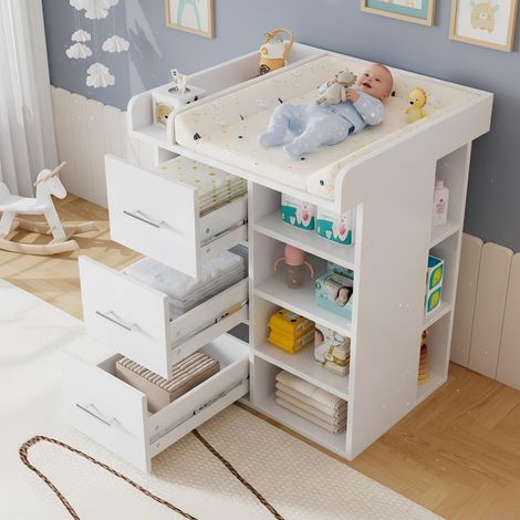 Table à langer blanche avec 3 tiroirs, beaucoup d'espace de rangement y compris des rangements latéraux, des étagères réglables et un espace à langer avec séparateurs. (1/5)