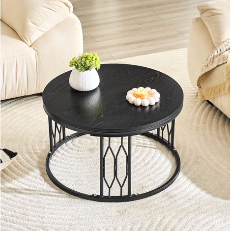 Mesa baja redonda negra 70x40,5 cm con acabado efecto madera, estructura geométrica de metal y almacenamiento abierto (1/5)