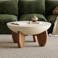Table basse ronde en béton beige finition noyer pieds en frêne massif design moderne pour salon