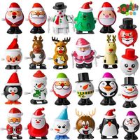 Assortiment de 24 jouets de Noël à remonter, comprenant un Père Noël, un bonhomme de neige, un renne et un pingouin. Idéal pour le,i