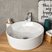 Lavabo da appoggio rotondo in ceramica ELYNA con interno dal design a forma di diamante.