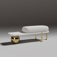 Un banc d'entrée moderne blanc et or, avec des coussins ronds en tissu doux et des pieds en métal au design abstrait