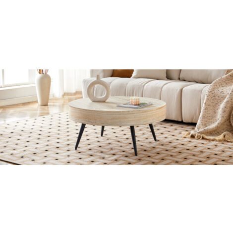 Table basse ronde d'un diamètre de 70 cm, présentant une finition en bois effet travertin clair (MDF) et des pieds en métal noir. Design minimaliste — idéal pour les salons et les petits espaces.