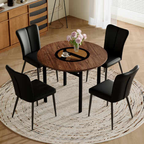 Table de repas moderne et minimaliste en forme ronde (avec 4 chaises en tissu noir). La table est ronde, avec un diamètre de 100 cm. Elle est conçue dans un style bois. Parfait pour les salons à mange