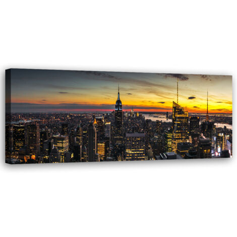 Tableau sur toile Ville sur fond de soleil couchant 90x30