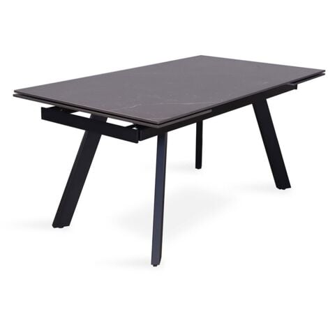 Tavolo da pranzo estensibile per 10 persone con piano in pietra nera della collezione LAROS. Struttura in metallo.