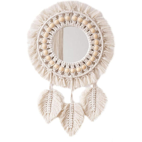 Un miroir décoratif rond mural à pompons, orné d'un pendentif en forme de plume, convenant aux appartements, aux chambres familiales et aux salons.