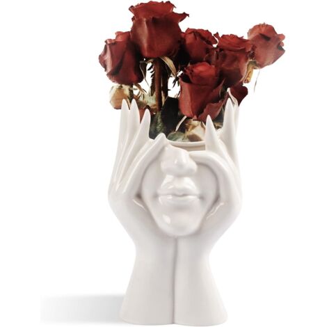 Un vase en céramique blanche orné d'un visage humain est un choix idéal pour décorer votre maison, votre salon ou votre bureau.