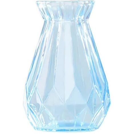 Vase bleu transparent en verre épais, décor hydroponique avec composition florale origami et plantes vertes.